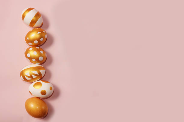 istock Decorated golden easter eggs on a pink background. Minimal holiday concept. Happy easter background. Creative painting of eggs at home. 1201519878