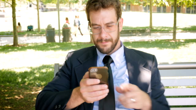 Portrait of successful businessman texting and reading mobile phone