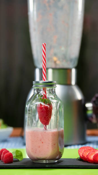 istock Delicious looking strawberry milkshake with blender in the background 1201522406