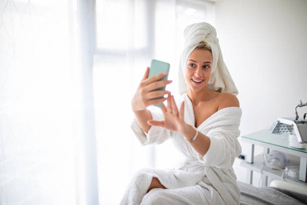istock Cute young woman taking selfies while visiting a spa 1201523209