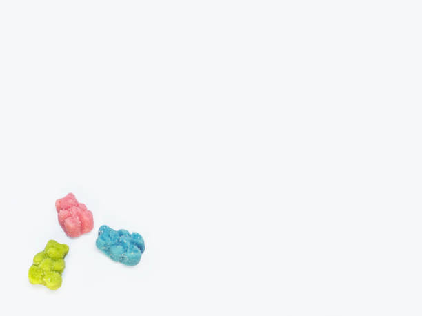 CBD medicinal sour candy gummies used for healing Colorful set of 3 CBD infused medicinal sour candy gummies used for healing on a plain white background cannabis gummy bears stock pictures, royalty-free photos & images