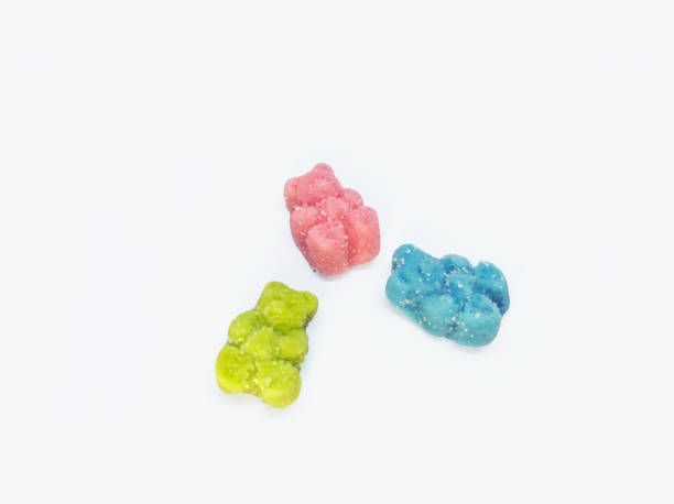 CBD medicinal sour candy gummies used for healing Colorful set of 3 CBD infused medicinal sour candy gummies used for healing on a plain white background cannabis gummy bears stock pictures, royalty-free photos & images