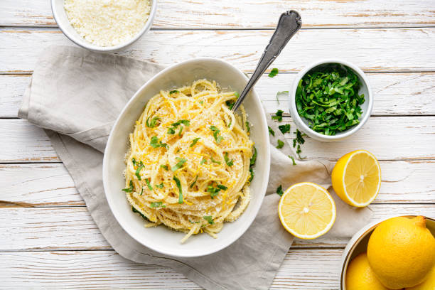 Pasta al Limone, delicious Italian meal, spaghetti with Parmesan, butter and lemon sauce, topped with fresh grated zest and cheese stock photo