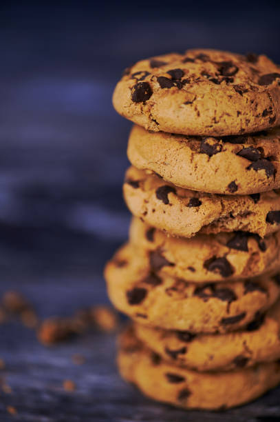istock stack of chocolate chips cookies against wooden background 1201529056