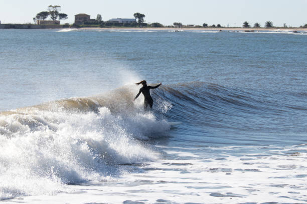 istock Young woman surfing a wave 1201529266