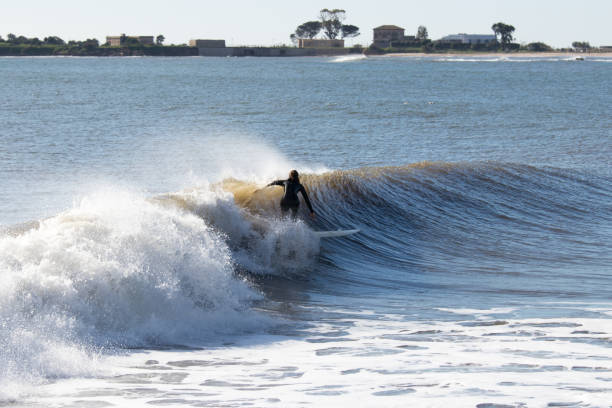 istock Young woman surfing a wave 1201529528