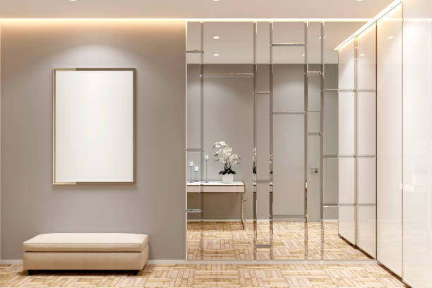 Bright modern hallway interior with a mirror, a blank mockup poster, a bench, a wardrobe and a parquet floor. Front view.