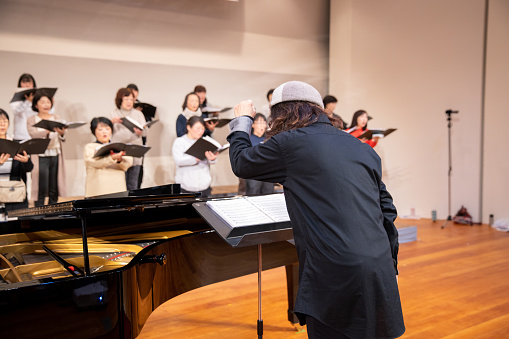 Musical conductor leading women's chorus