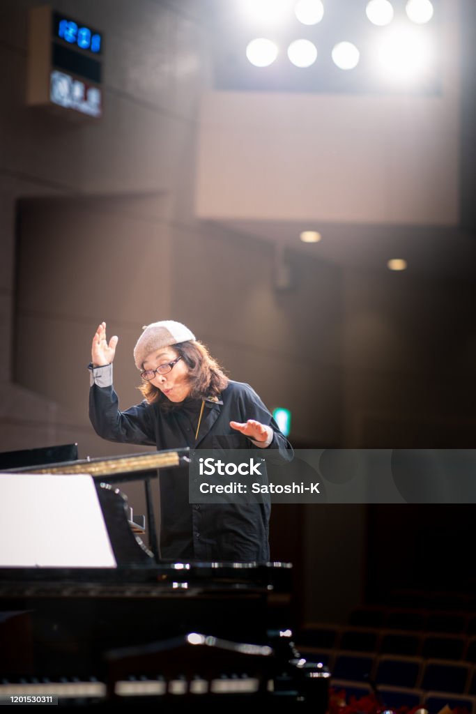 Musical conductor in concert hall Musical Conductor Stock Photo