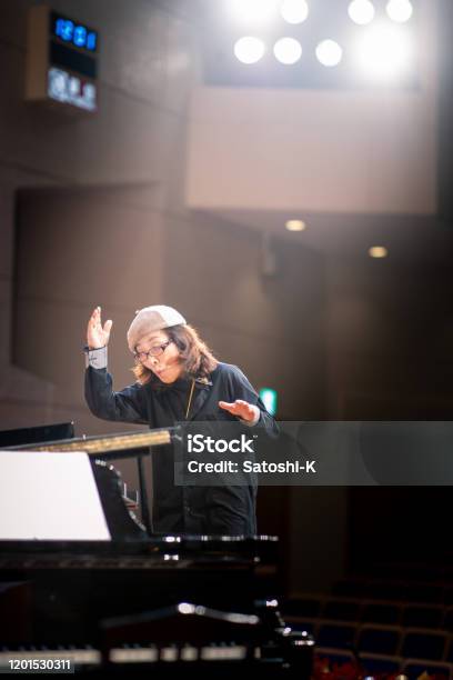 Musical Conductor In Concert Hall Stock Photo - Download Image Now - Musical Conductor, Choir, One Woman Only