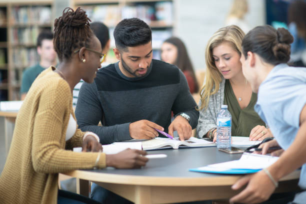 istock Group of Post Secondary Students Studying stock photo 1201530731