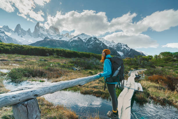 Woman hiking near  Fitz Roy mountain in Patagonia Young Caucasian woman hiking near  Fitz Roy mountain in Patagonia fitzroy range stock pictures, royalty-free photos & images