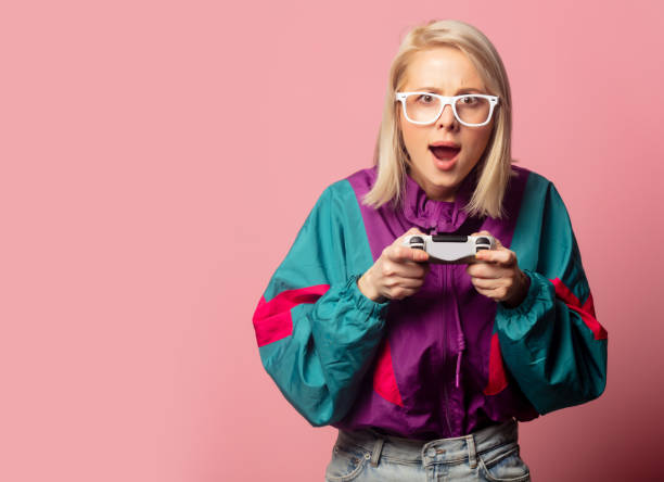 beautiful blonde woman in 90s clothes with joystick - clothing fashion model old fashioned women imagens e fotografias de stock