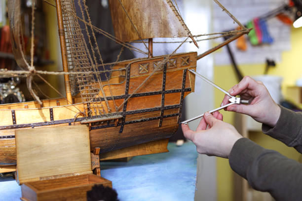 istock Female designer making a wooden boat model 1201539039