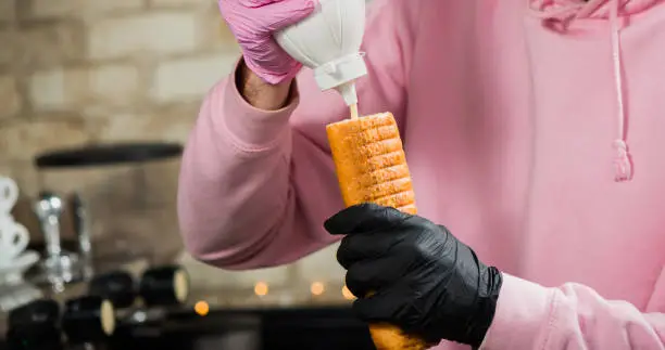 Photo of bartender adding sauce in roll