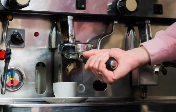 Photo of bartender making espresso