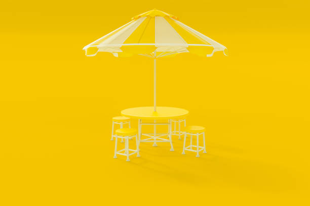 istock Yellow table and chairs and umbrella 1201539706