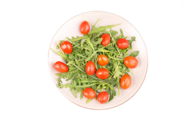 istock Red cherry tomatoes and arugula leaves, mix salad 1201540632
