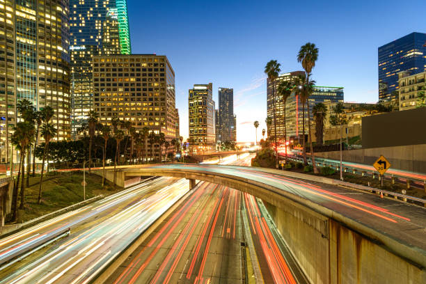 istock Downtown Los Angeles at night with car traffic light trails 1201540661