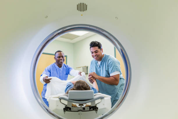 istock Technologist talking to girl getting CT scan 1201542057