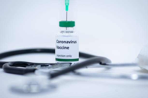 istock Coronavirus vaccine with stethoscope and syringe at the background 1201544376