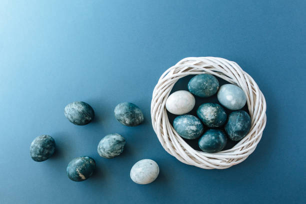 istock Group of light blue eggs in their nest on a blue background. Happy Easter decoration 1201545391
