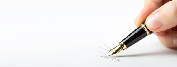 istock hand signing blank paper with fountain pen. horizontal ready banner 1201546087