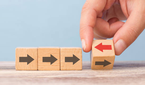 istock man turns the arrows going in the same direction in the opposite direction. innovation concept 1201550250