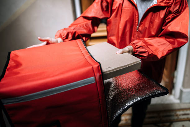 istock Man delivering food and looking for right apartment 1201555937