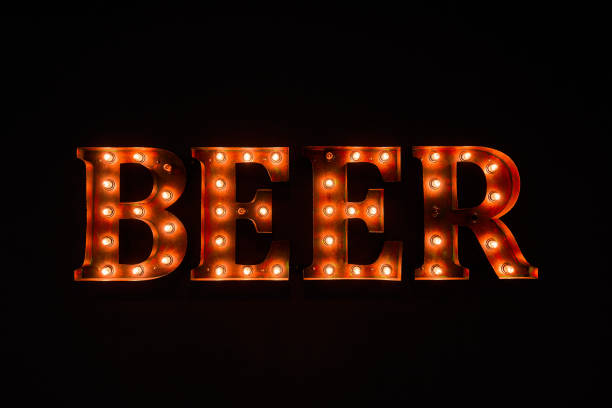 istock large luminous inscription BEER from light bulbs, in the dark 1201557190