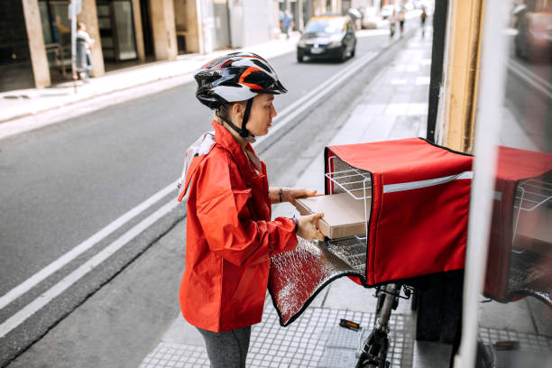 istock Woman delivering food 1201558315