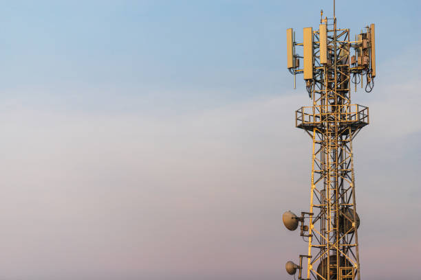 istock Communication Tower with Parabolic and GSM Antennas on blue sky background with copy space. 1201567219
