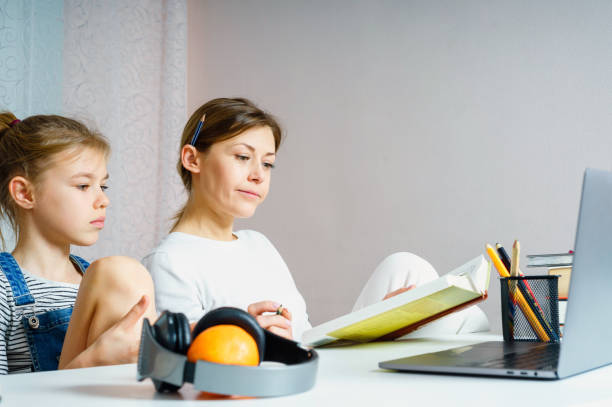 istock Mother and daughter doing homework for school together, education concept 1201569539