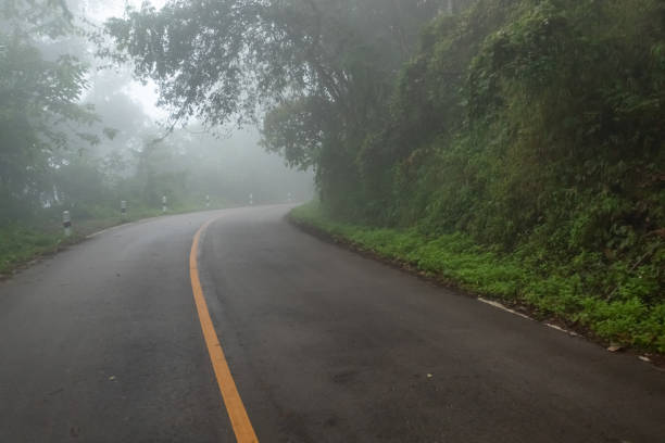 istock Foggy road on the mountain. 1201577021