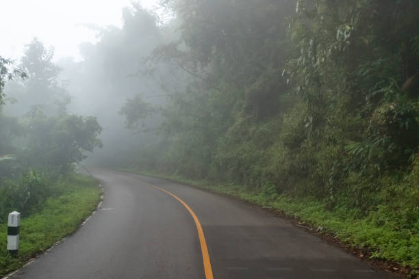 istock Foggy road on the mountain. 1201577026