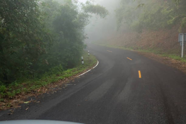 istock Foggy road on the mountain. 1201577144
