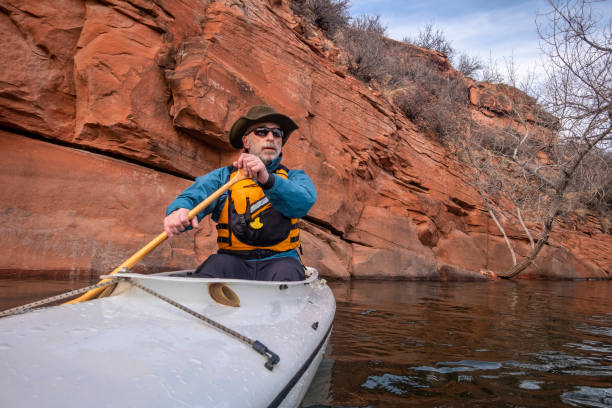 istock senior male is paddling expedition canoe 1201578714