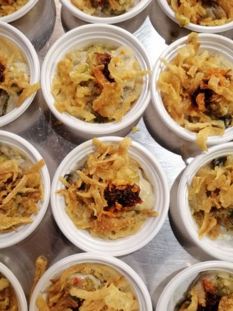 Oyster in dipping sauce and spices in white cup