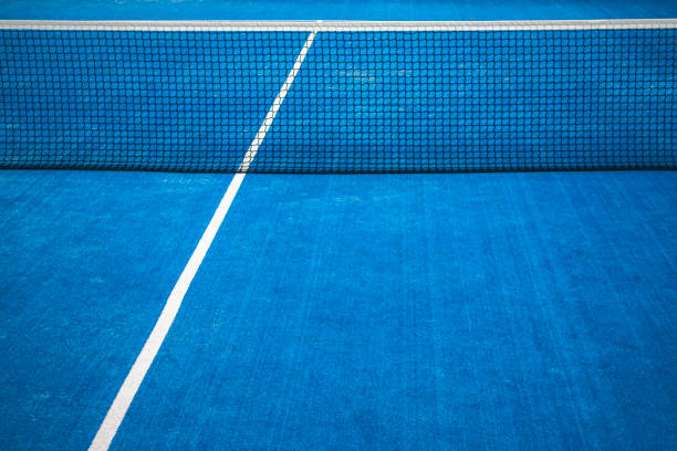 istock Blue paddle tennis net and court field background 1201591046