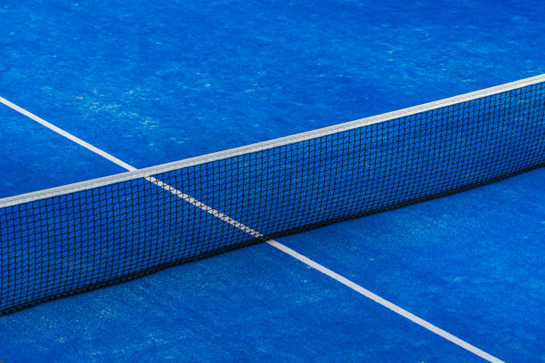 istock Blue paddle tennis net and court field background 1201591190