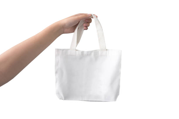 istock women hand holding cloth white bag on white background 1201591805