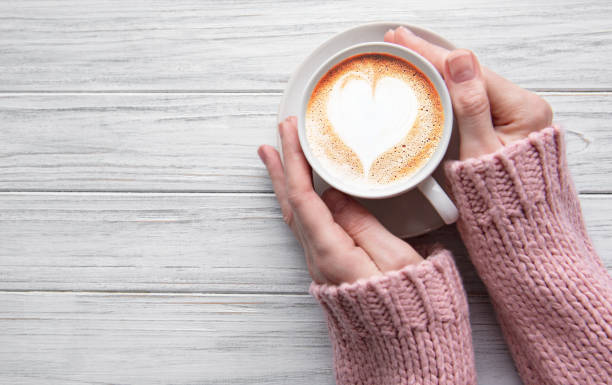 istock Woman holding cup of coffee 1201593459