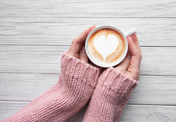istock Woman holding cup of coffee 1201593469