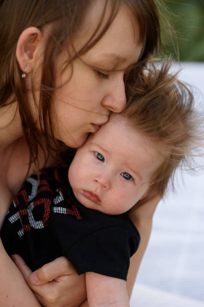 istock Young mother hugging cute baby outdoor 1201593707