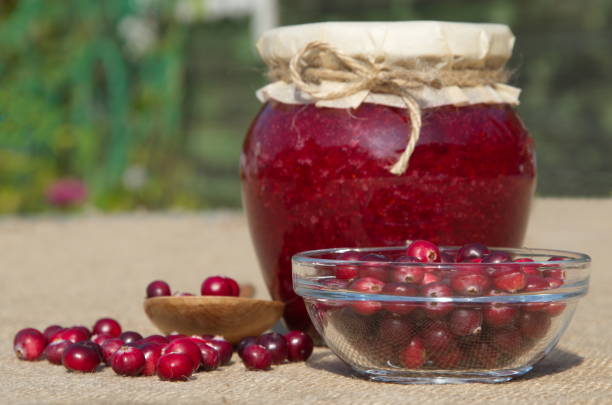 istock Cranberries pureed with sugar and fresh berries in a cup close up 1201594848