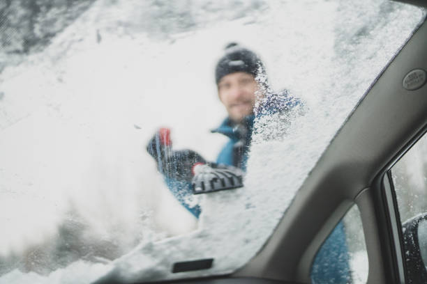 istock Scraping ice and snow from car window 1201595547