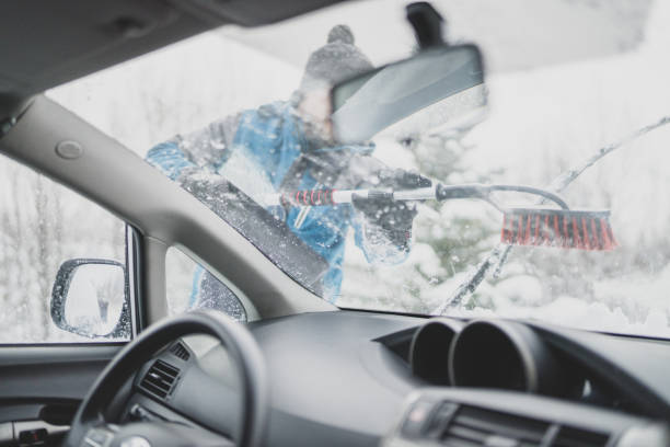 istock Scraping ice and snow from car window 1201595894