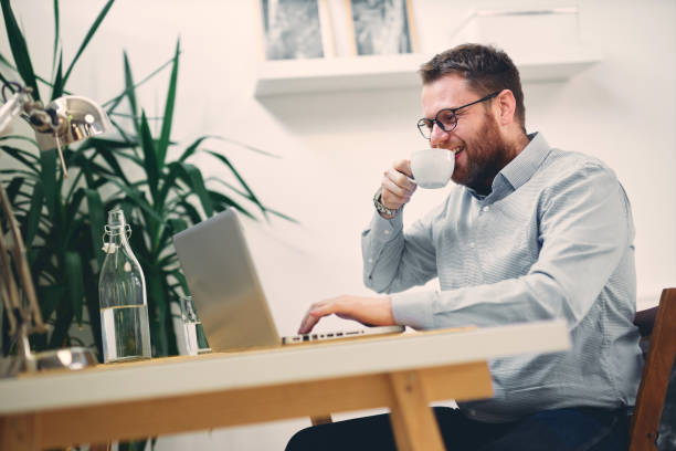 istock Modern architect sitting in his office drinking coffee and typing email. 1201597930