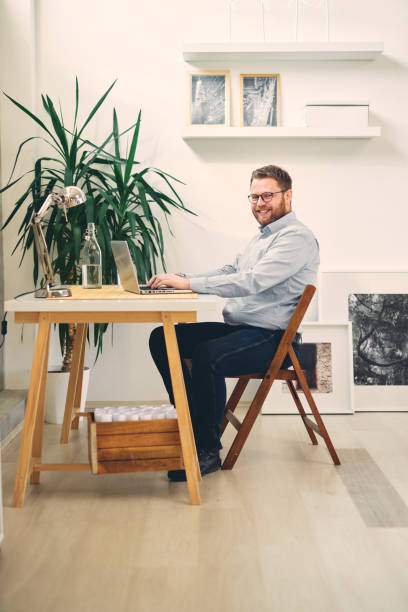 istock Young male architect sitting at his desk in modern office. 1201597995
