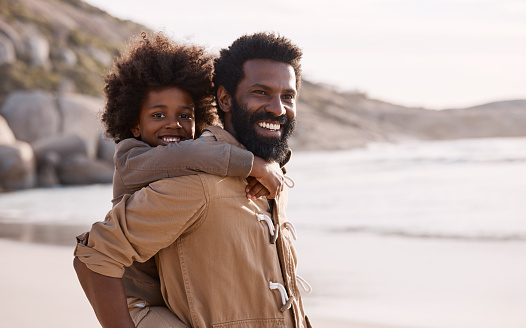 Shot of an adorable little boy having a fun day at the beach with his father